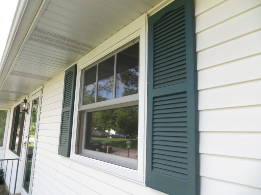 Fenton, MO window replacement with crisp white framing and classic shutters that enhance the home’s curb appeal
