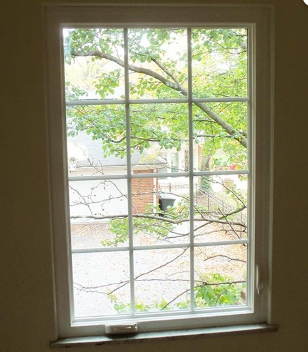 a-large-grid-style-casement-window-chesterfield-mo-window-replacement-service A large grid-style casement window brings in natural light, highlighting the value of Chesterfield, MO window replacement service