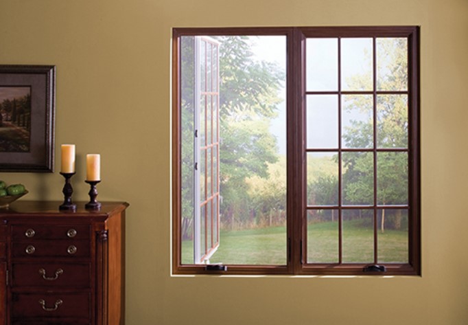 Open casement windows welcome fresh air and scenic garden views with Fenton, MO window replacement